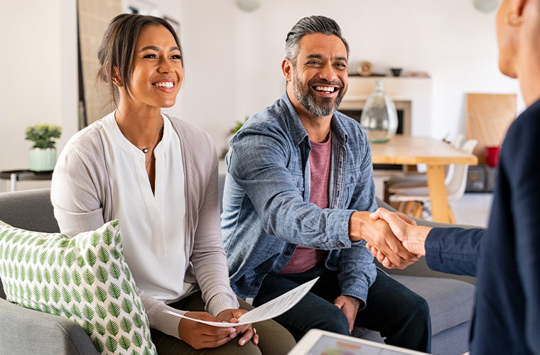 young couple meeting with financial advisor to discuss how to pay off your debt